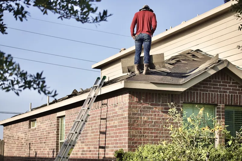 Professional roofer working on a residential roof in Terrell Mill Estates